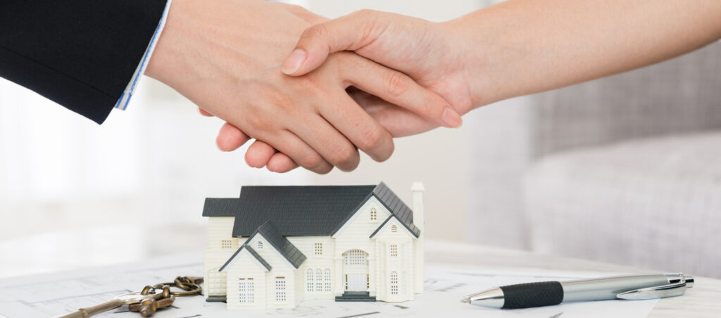 house agent successfully selling building scheme concept - business lady with investor buyer finished deal and handshake.